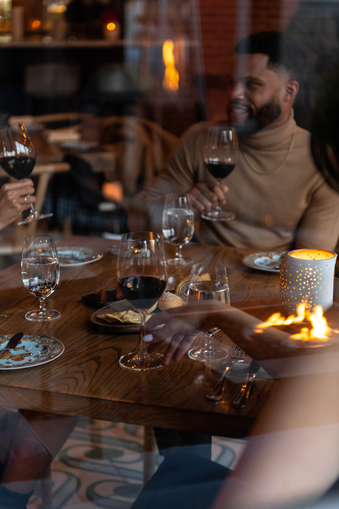A group of friends drinking together in a fine dining restaurant