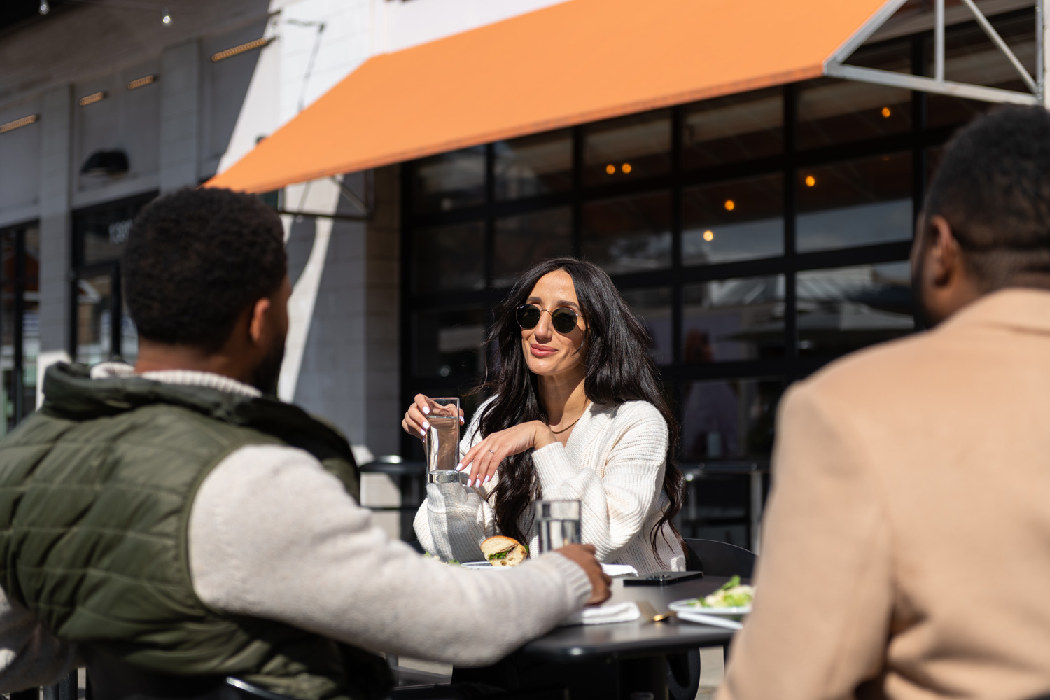 Friends hanging out outside on a patio at a dinning destination