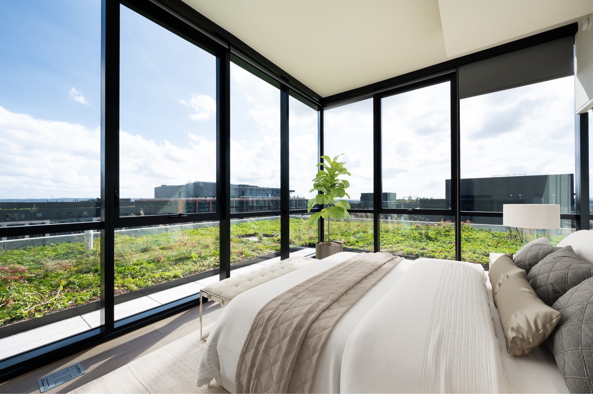 Margarite luxury apartments' penthouse bedroom with stunning city view in Washington, DC.